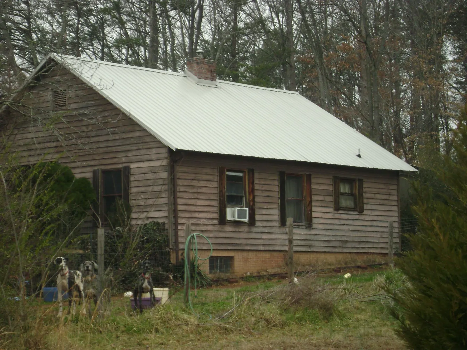 White metal roof on an old wood sided farmhouse, from a Asphalt Shingle Roof Repair job in Van Buren